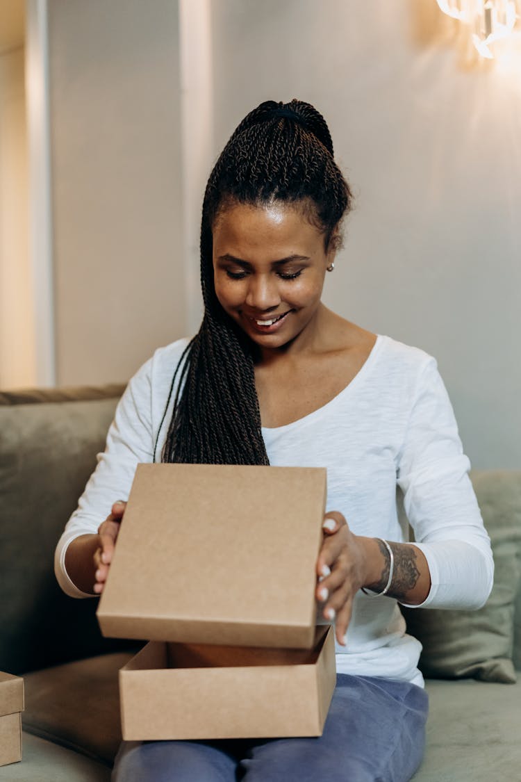 A Woman Opening A Box