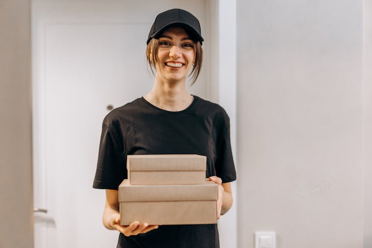 A Woman In Black Crew Neck T-shirt Making A Delivery