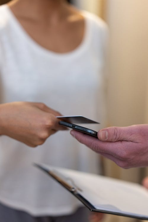 Free Hands Holding Credit Card and Smartphone  Stock Photo