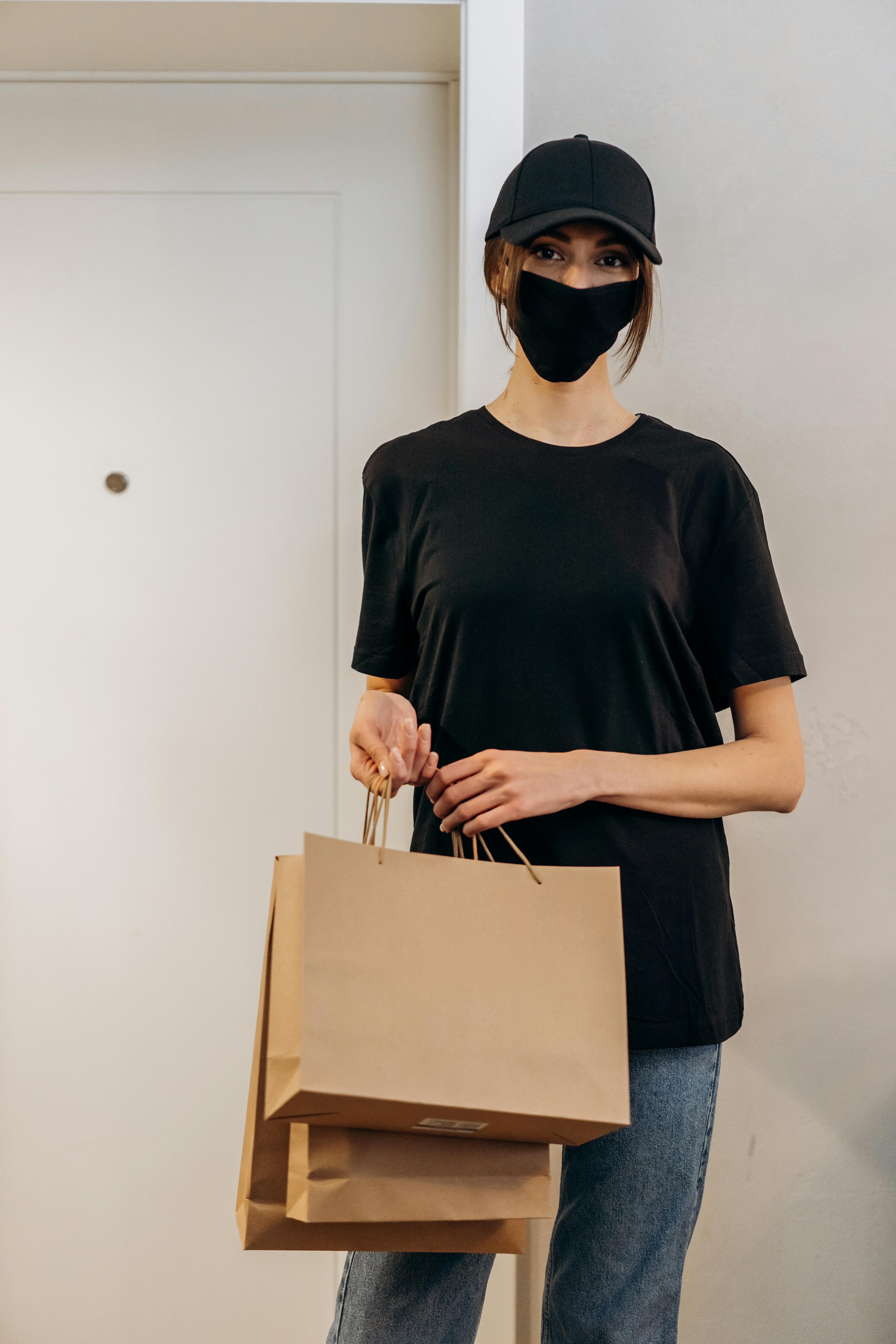 a woman in black shirt holding paper bags