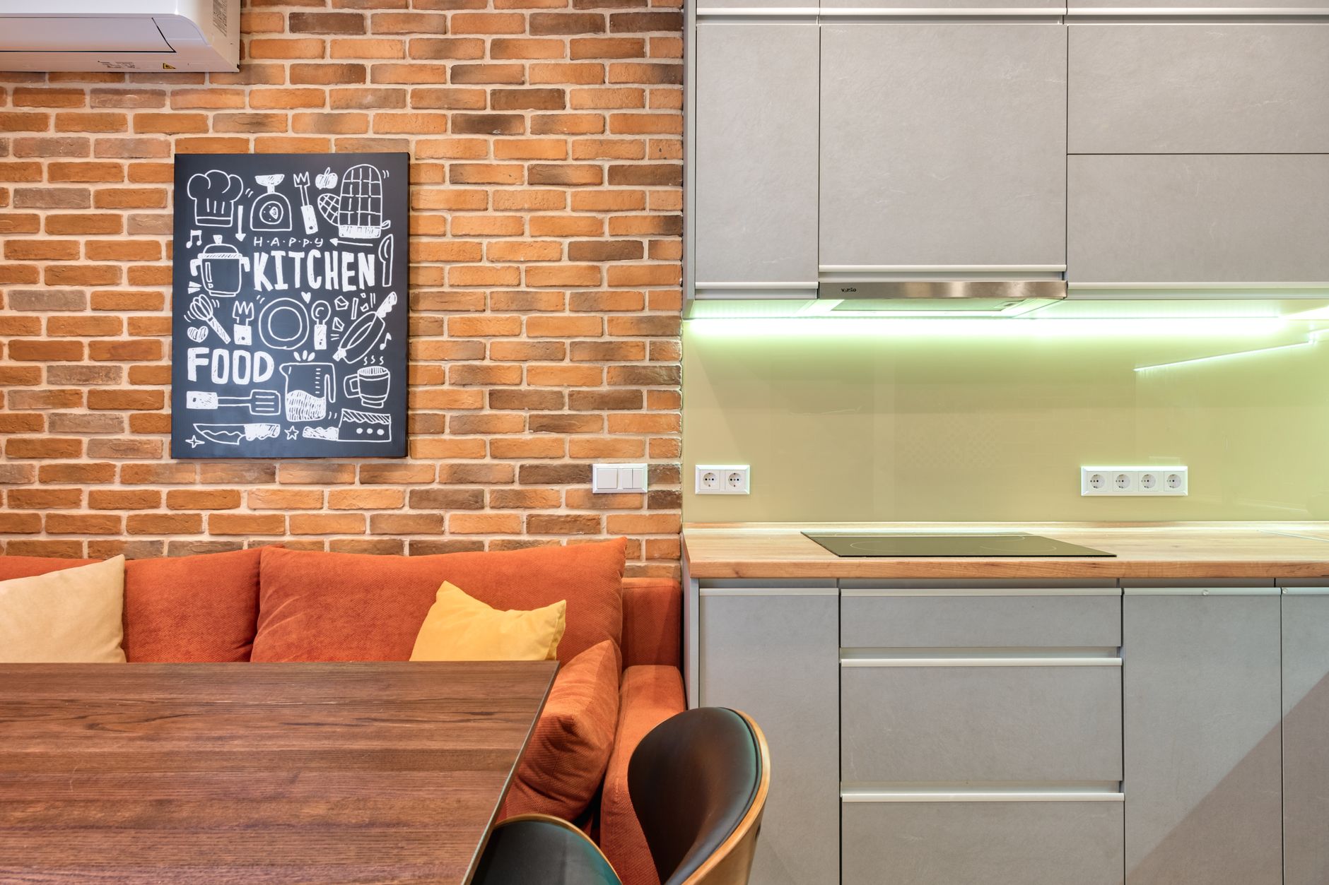 cozy kitchen layout for cozy homes Elegant kitchen area with modern cabinetry and brick wall decor, showcasing cozy design.