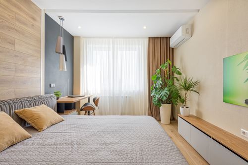 Free A modern bedroom featuring cozy decor, natural light, and indoor plants. Stock Photo
