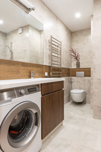 Photo by Max Vakhtbovych on Pexels Contemporary bathroom interior featuring a washing machine, toilet bowl, and sleek design elements.