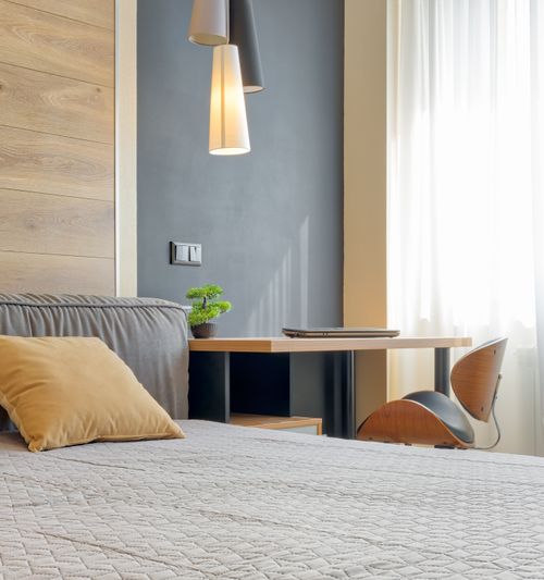 Free A contemporary bedroom setup featuring pendant lights and minimalist decor. Stock Photo