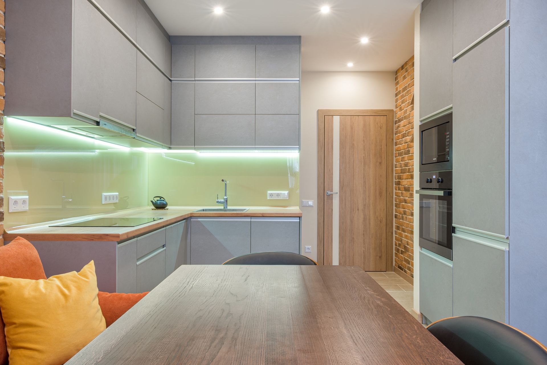 Brown Wooden Table Near Gray Kitchen Cabinets