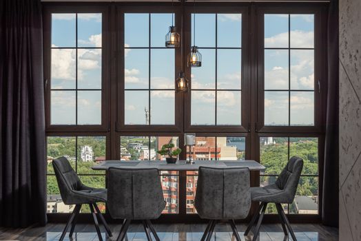 Stylish dining room with large windows overlooking a vibrant cityscape.