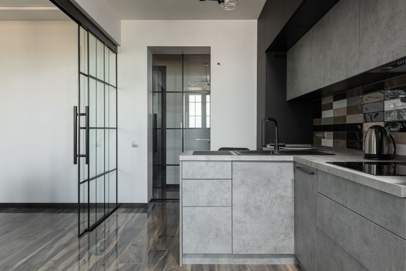 Charcoal kitchen run with a concrete-look island and tall units