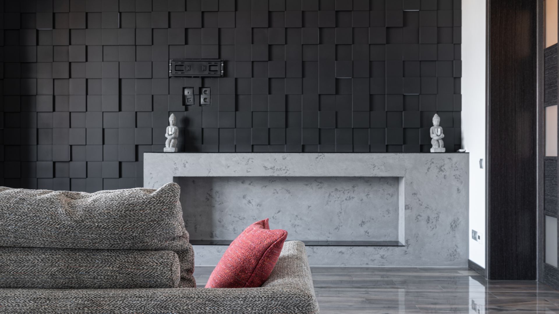 The Granite House — living room against sculptural black stone wall
