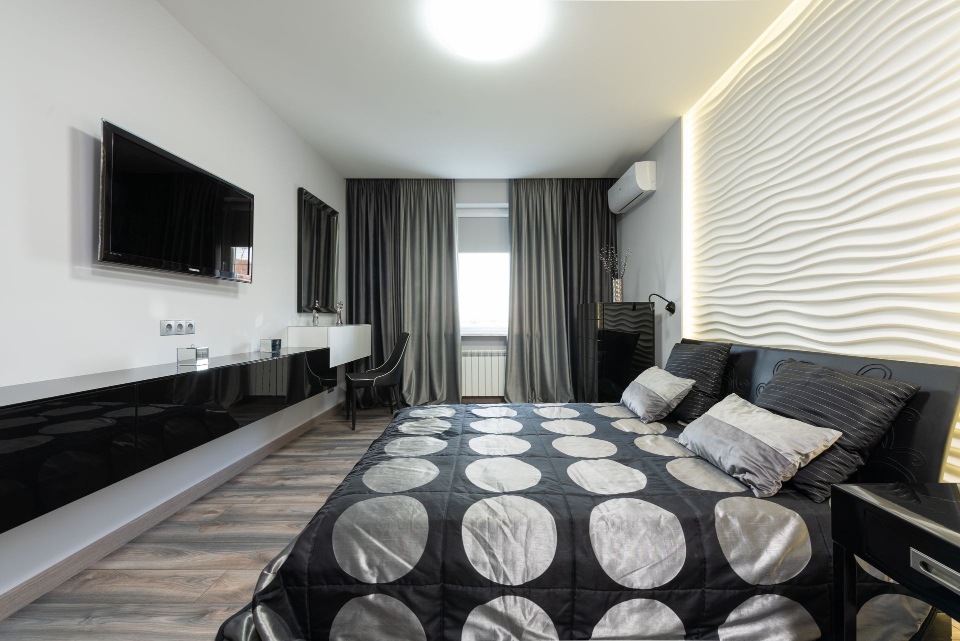 Interior of modern bedroom in white and black color with bed near window with dark curtains