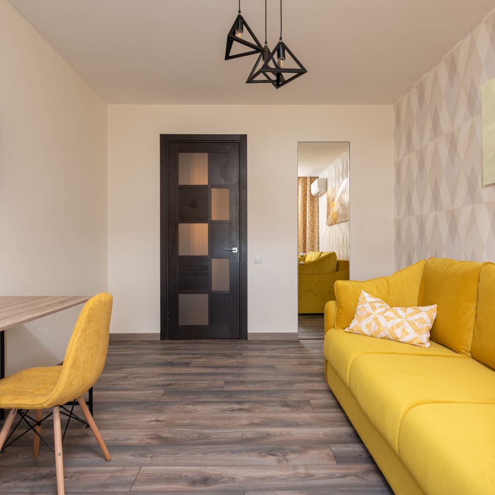 Wallpapering in West Hackney — clean edges cut in around trim and sockets