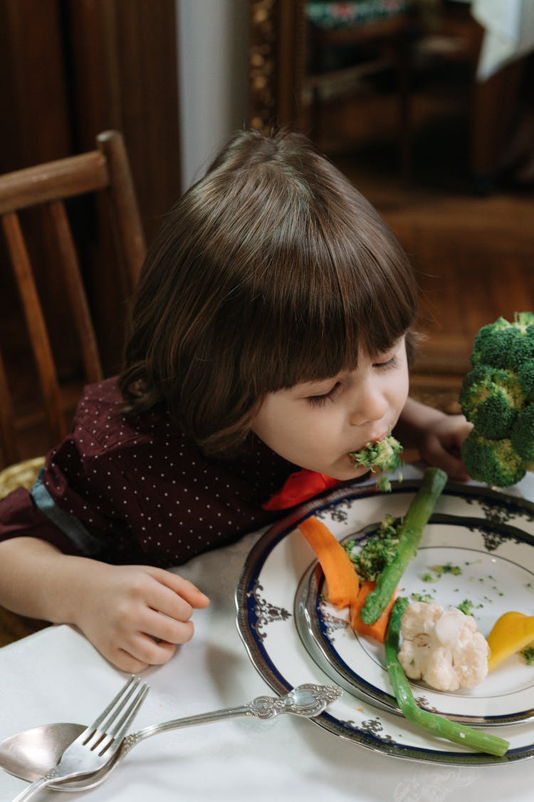 Kid Eating Broccoli