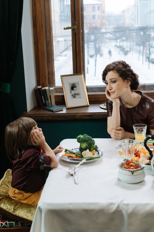 Free A Mother and Child Leaning on the Table Stock Photo