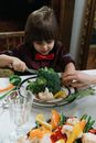 A Kid Eating Vegetables