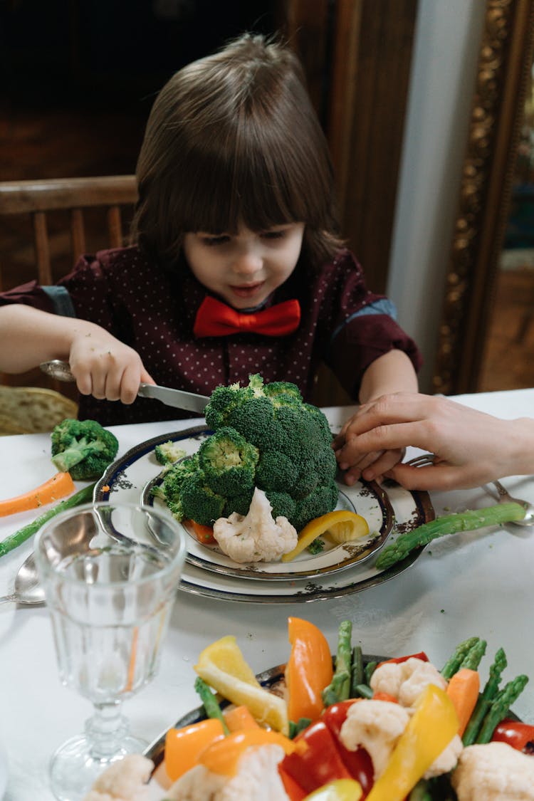 A Kid Eating Vegetables