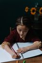 Woman in Red Long Sleeve Shirt Writing on White Paper