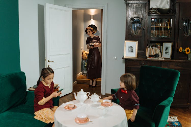 Woman Standing Near The Door Checking The Kids 