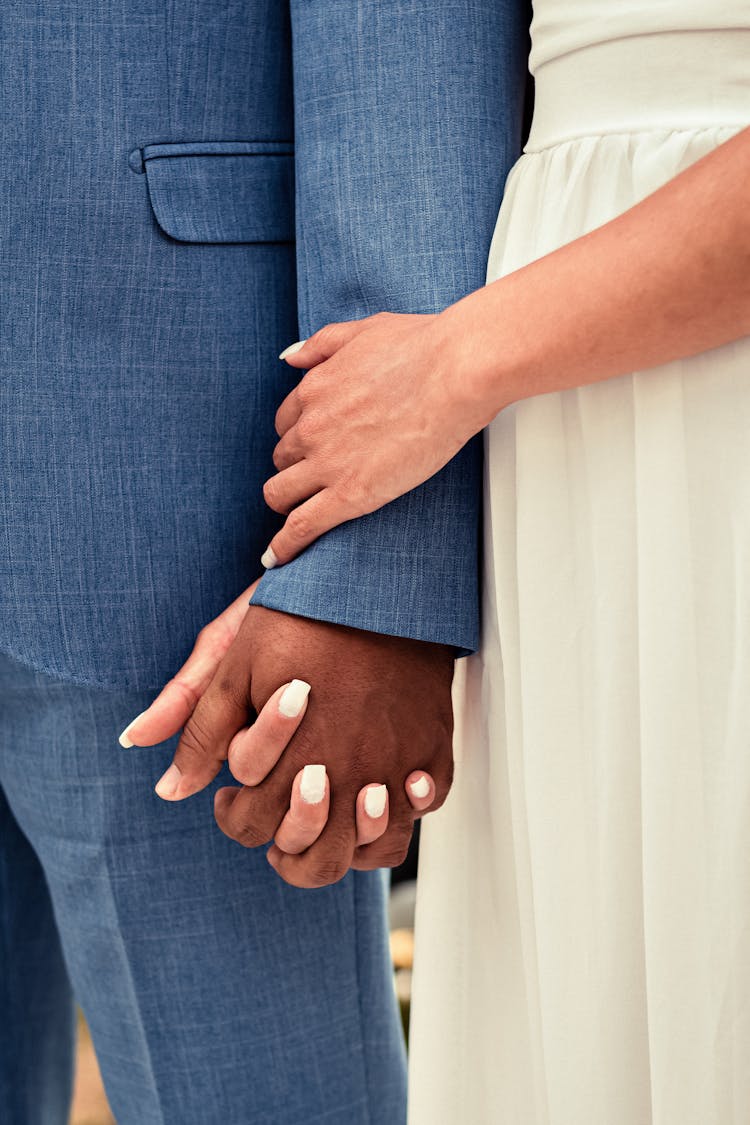 Multiracial Couple Holding Hands At Wedding