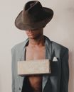 Man in Brown Hat and Gray Blazer