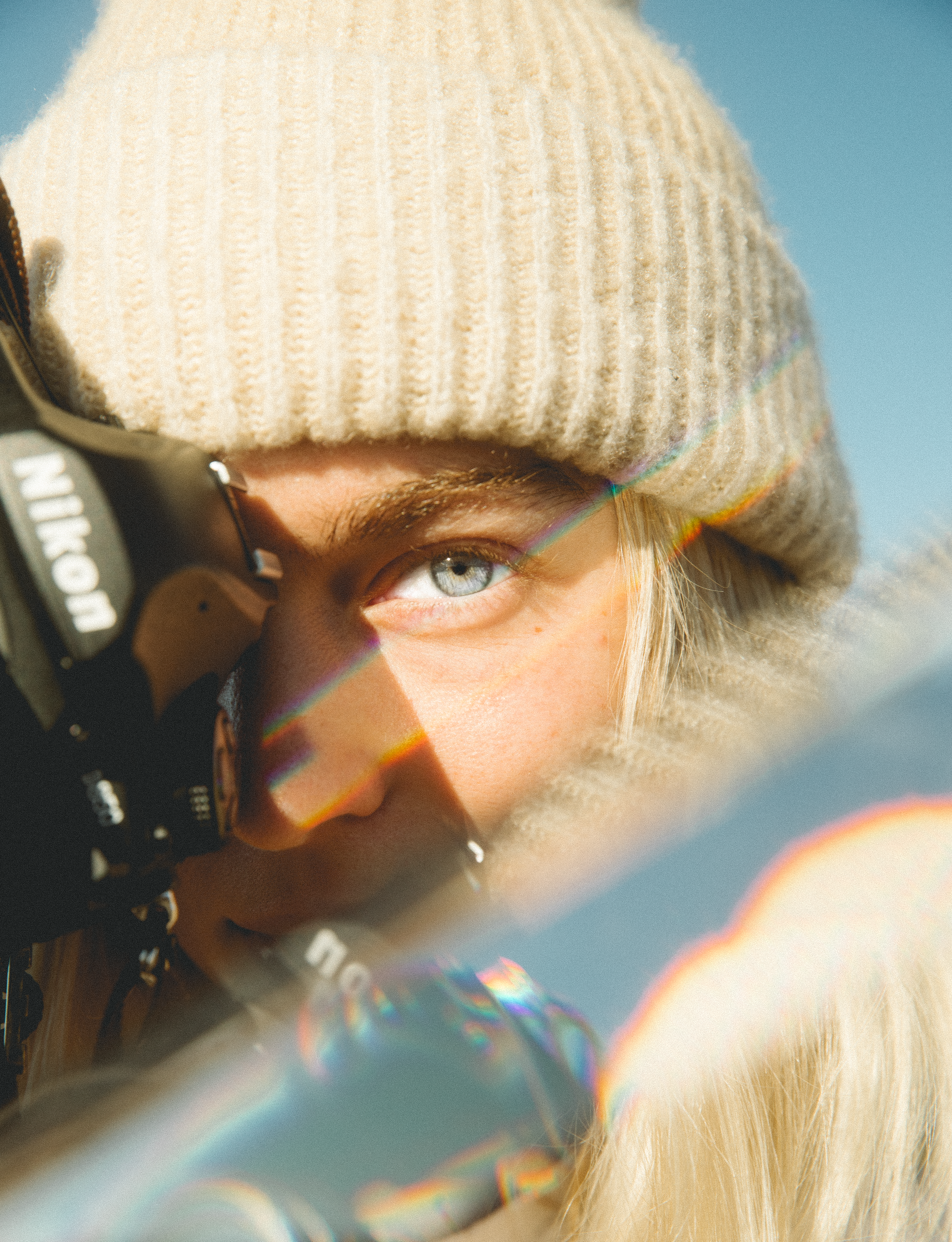 Artistic close-up of a photographer capturing the moment on a sunny day.