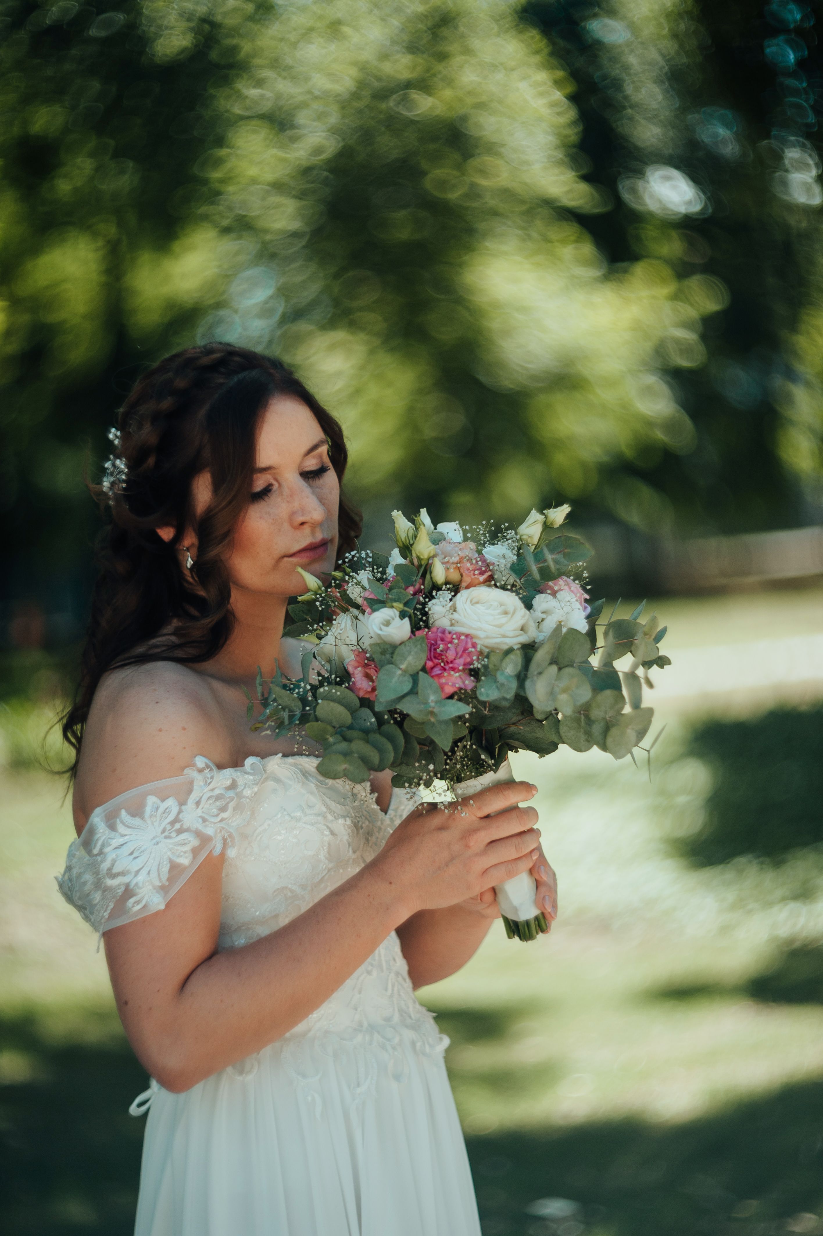 A Pretty Woman in White Dress Holding a Bouquet of Flowers · Free Stock ...