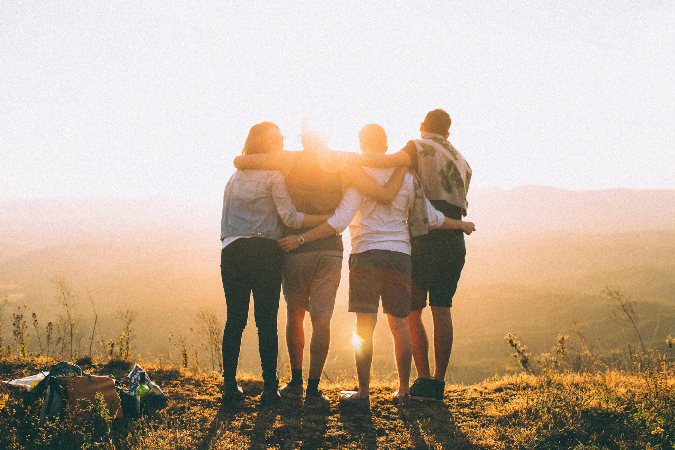 Friends looking at the sunset together.