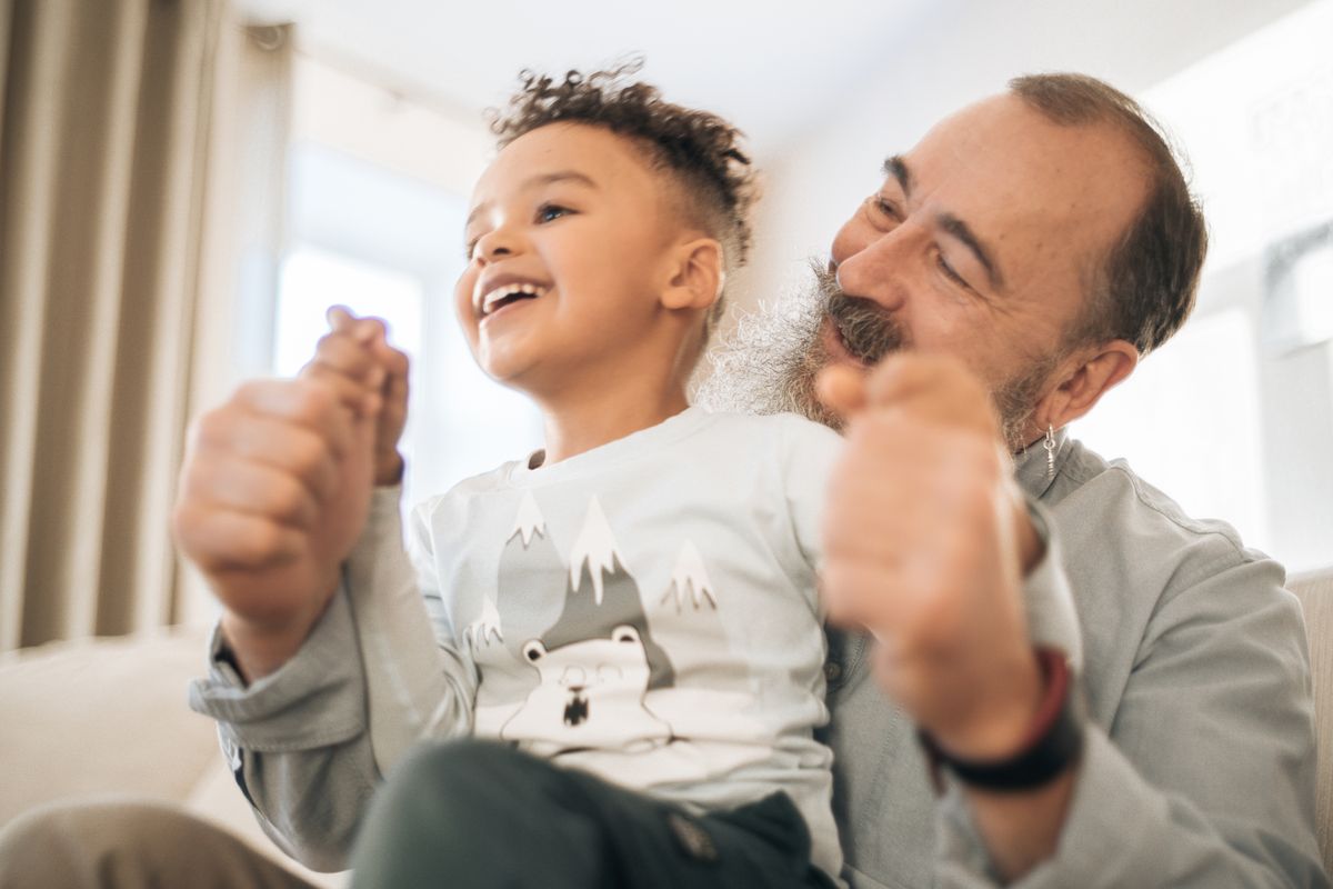 A grandfather and grandson sharing a happy moment together