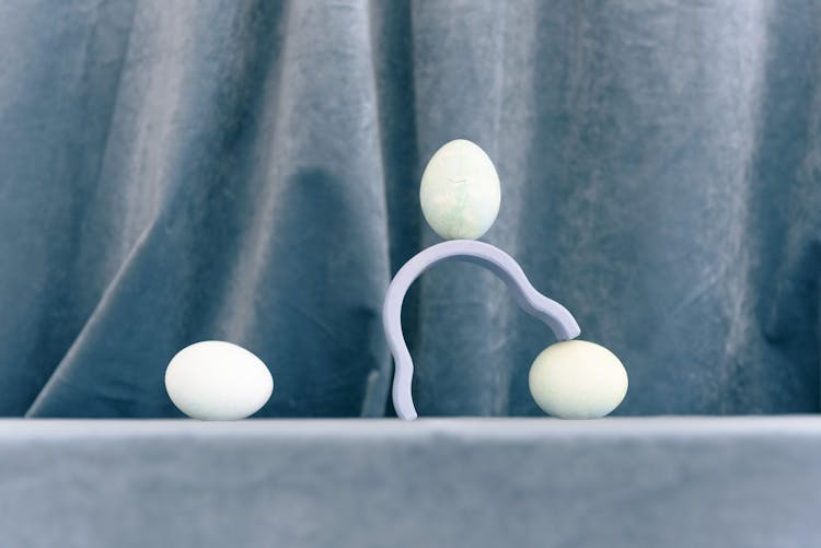 Studio Shoot Of White Eggs And Blue Drape In Background