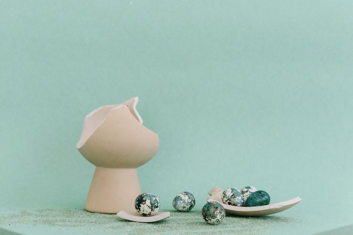 Still life of a cracked clay vessel and speckled stones — photo by Ksenia Chernaya on Pexels