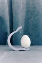 White Egg on a Concave Holder