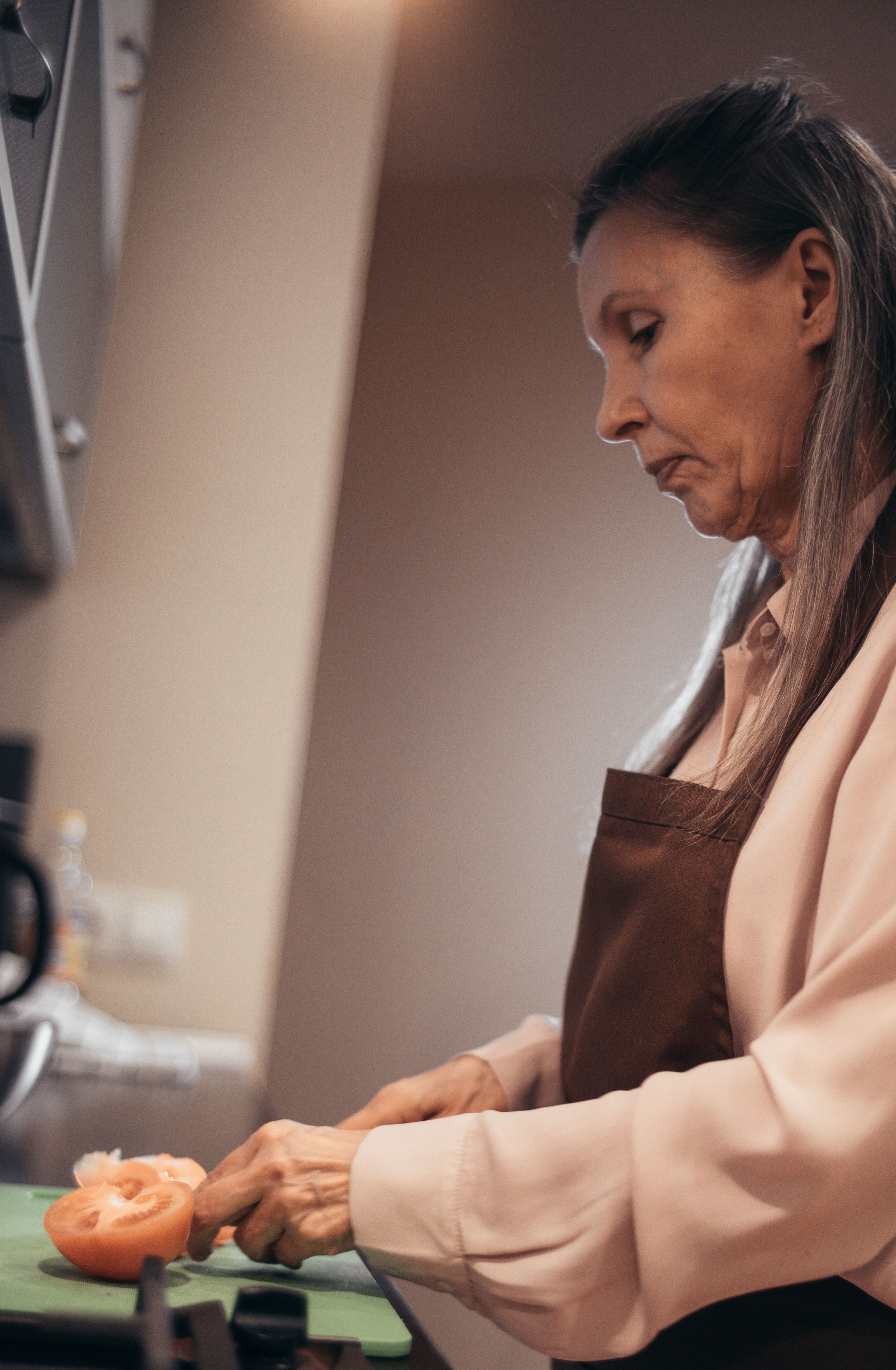 older person cooking protein meal at home