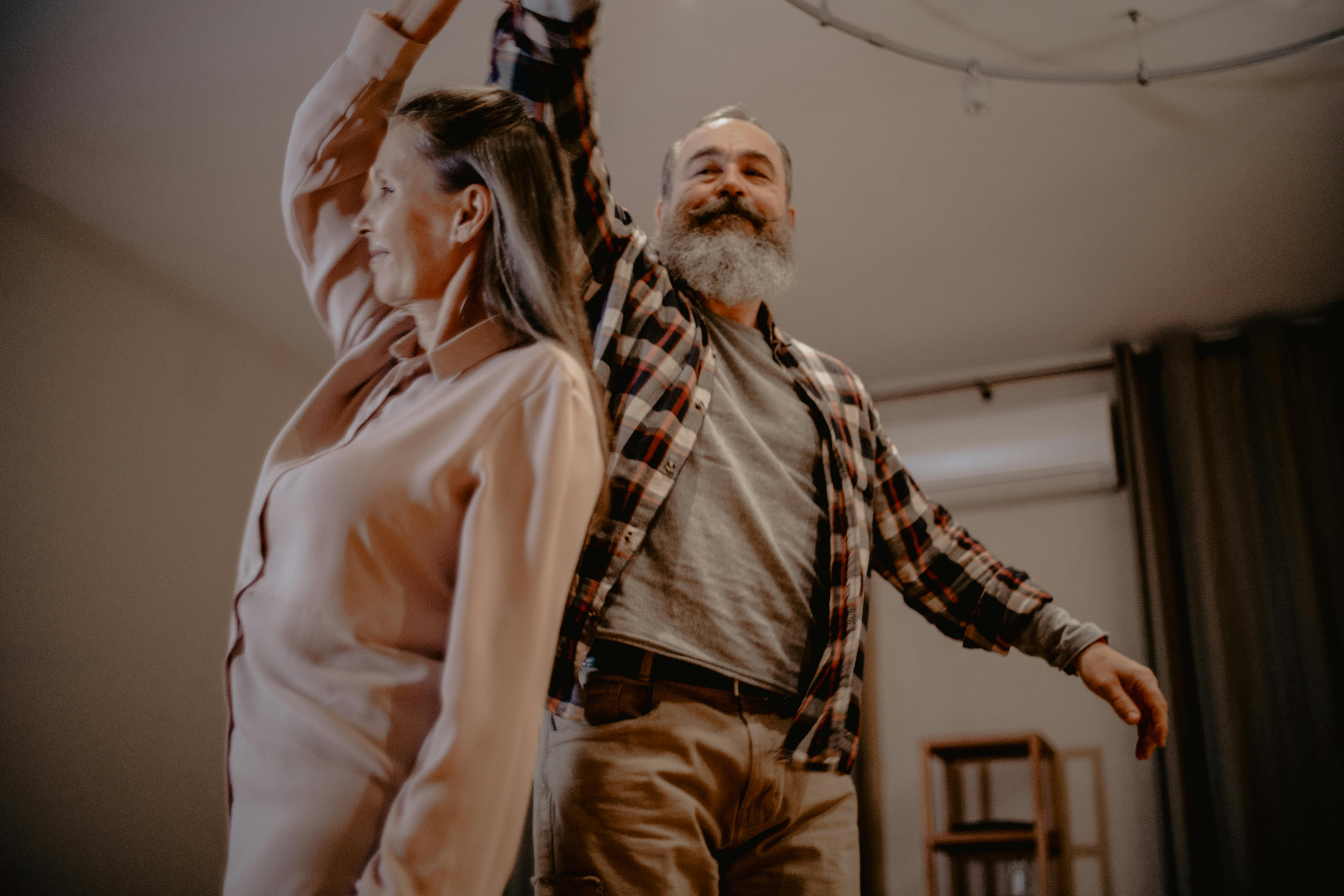 an elderly couple dancing in a living room