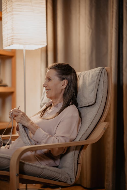 Elderly Woman Sitting on a Chair Knitting