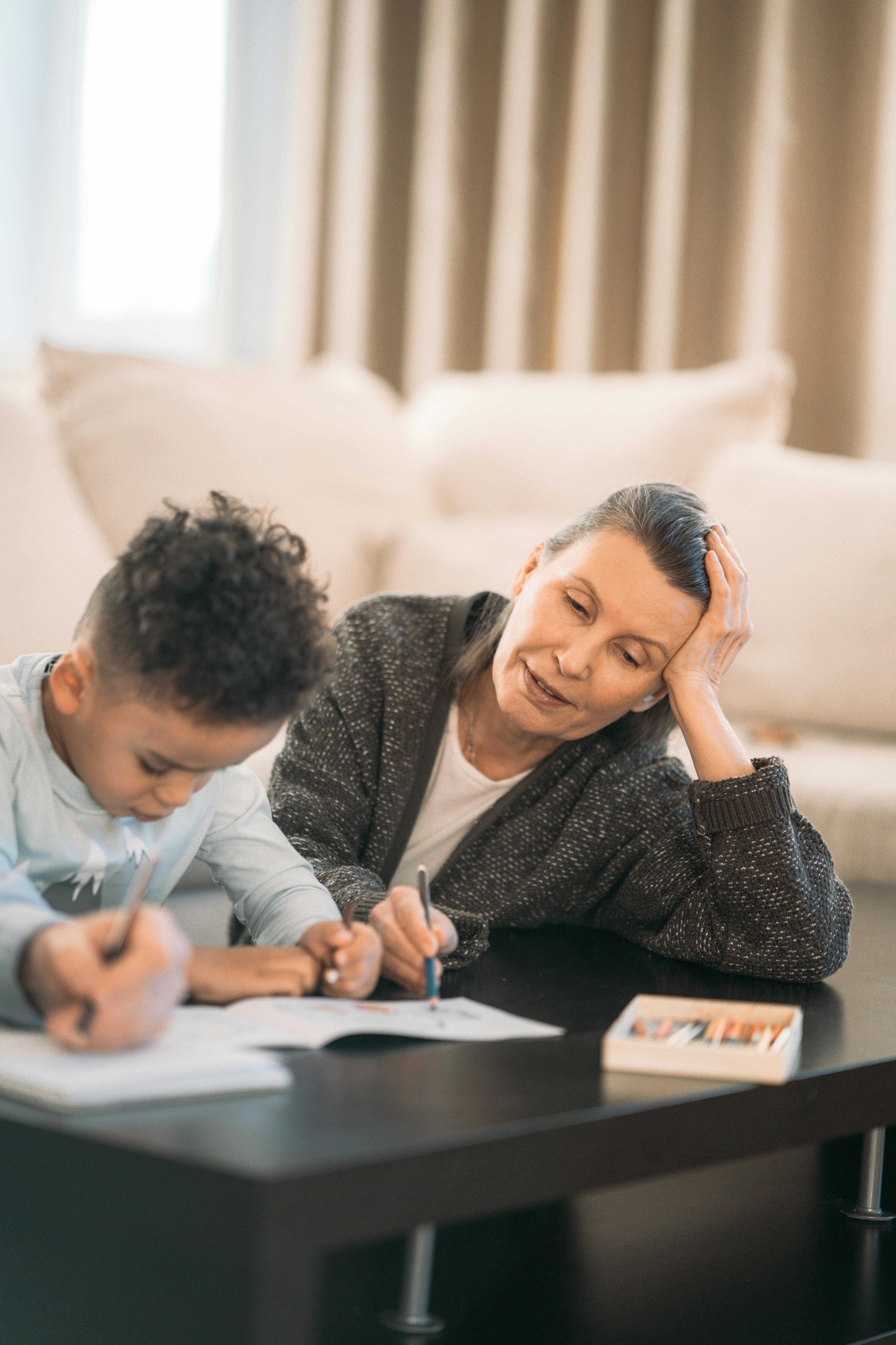 elderly woman studying with her grandson