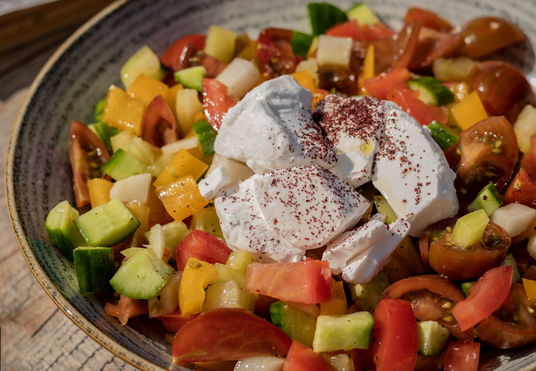 Bright plate of Mediterranean vegetable salad with olives and parsley garnish