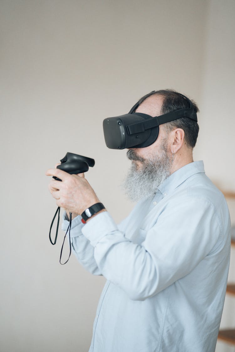 Man In White Dress Shirt Playing Video Game With An Oculus