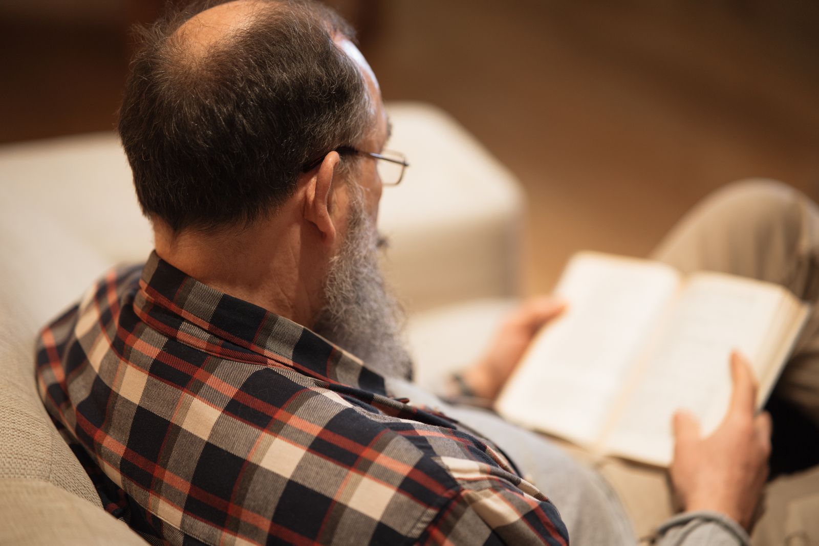Mature man relaxing with a book in the evening