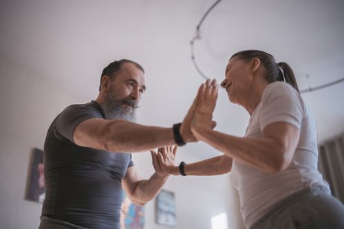 Free A joyous elderly couple dancing and connecting indoors, emphasizing love and friendship. Stock Photo