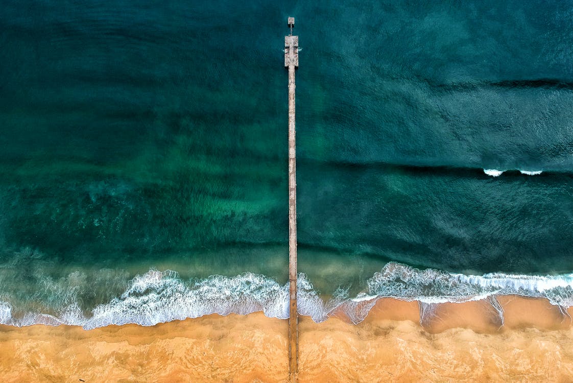 Aerial Shot of Gray Dock on Body of Water