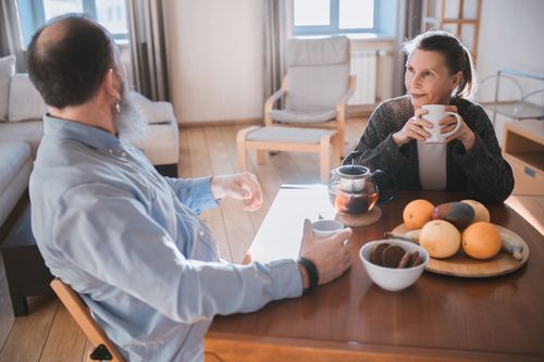 Free A senior couple having a relaxed morning with tea and fruits in a cozy living room. Stock Photo