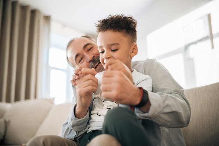 Grandpa And Grandson Playing In The Living Room