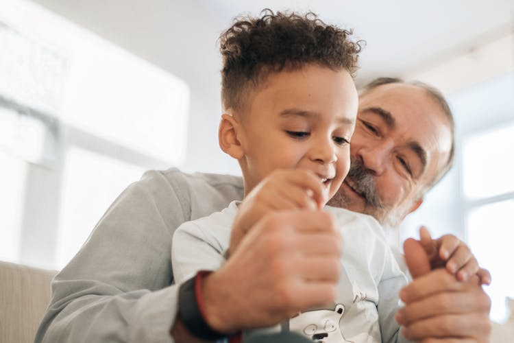 Grandpa And Grandson Playing In The Living Room