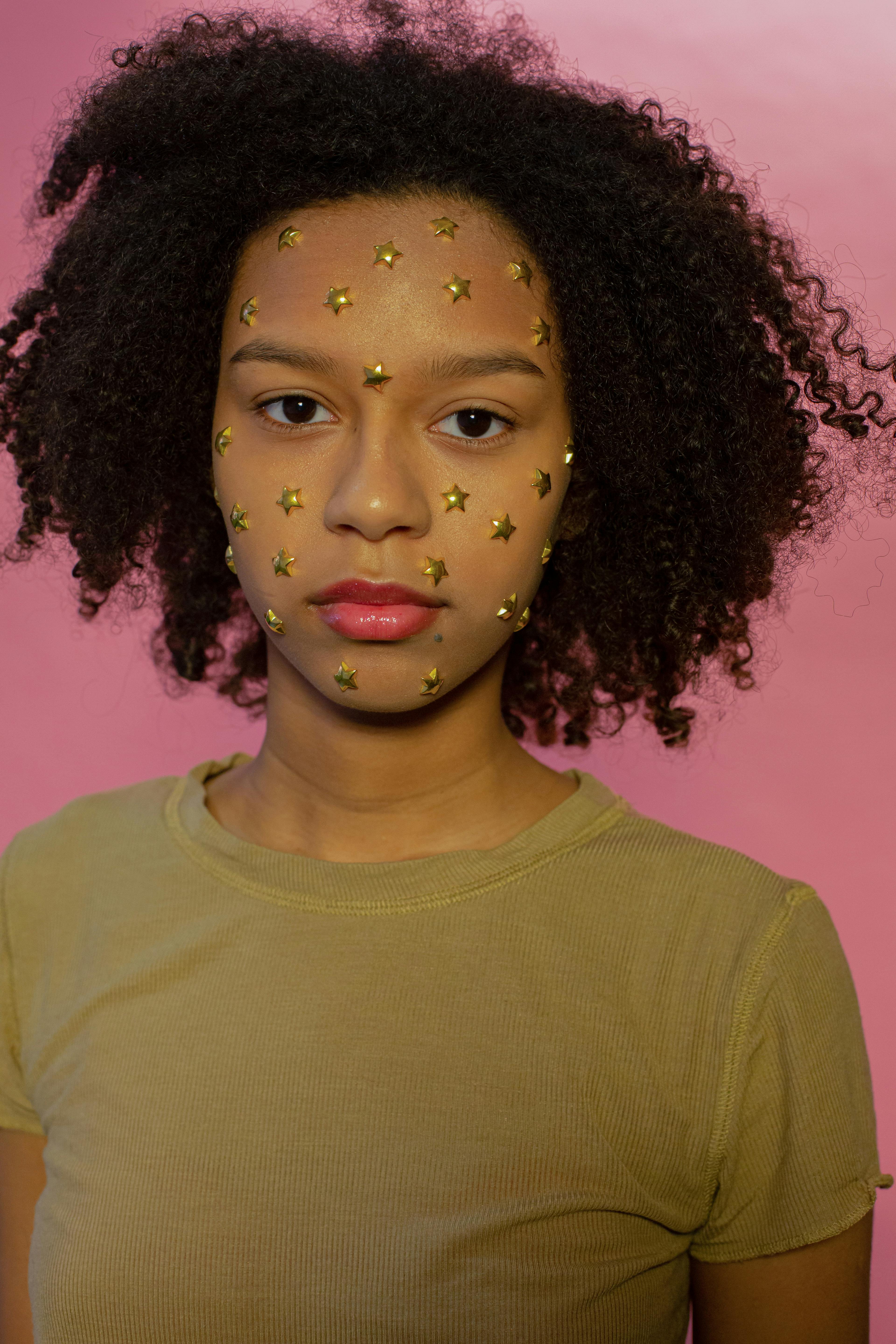 calm black girl with decorative stars on face