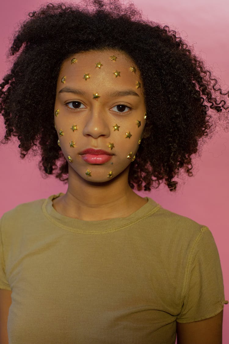 Calm Black Girl With Decorative Stars On Face