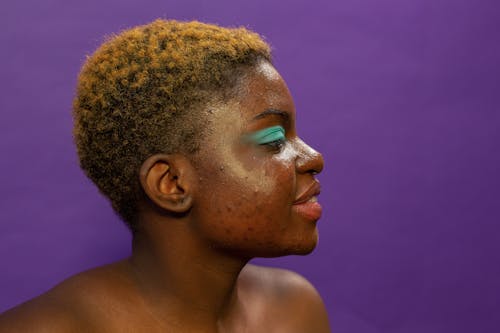 Cheerful black woman with bright makeup