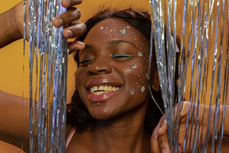 Happy Black Woman With Makeup And Sequins On Face