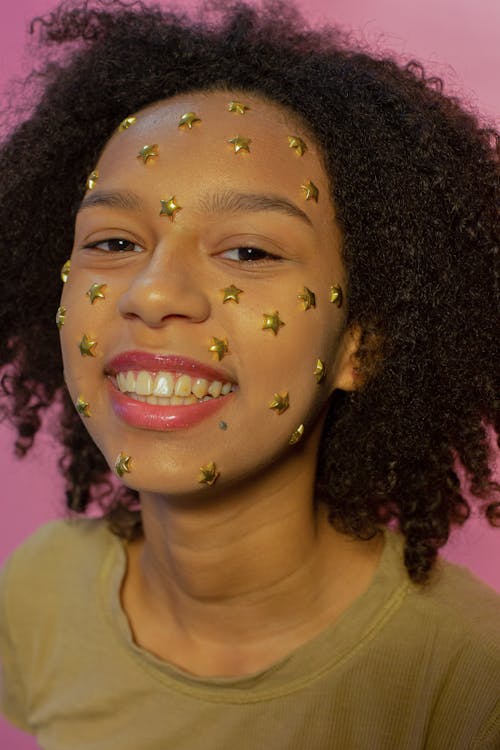 Free Black happy woman with sparkling stars on face Stock Photo
