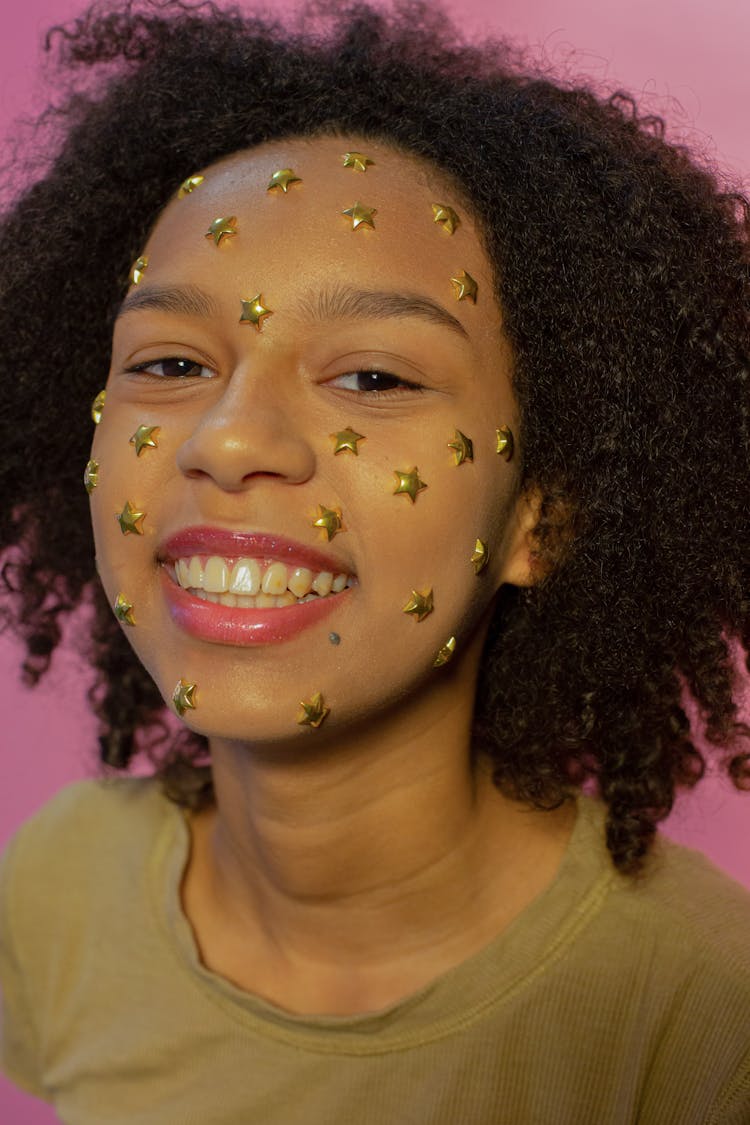 Black Happy Woman With Sparkling Stars On Face