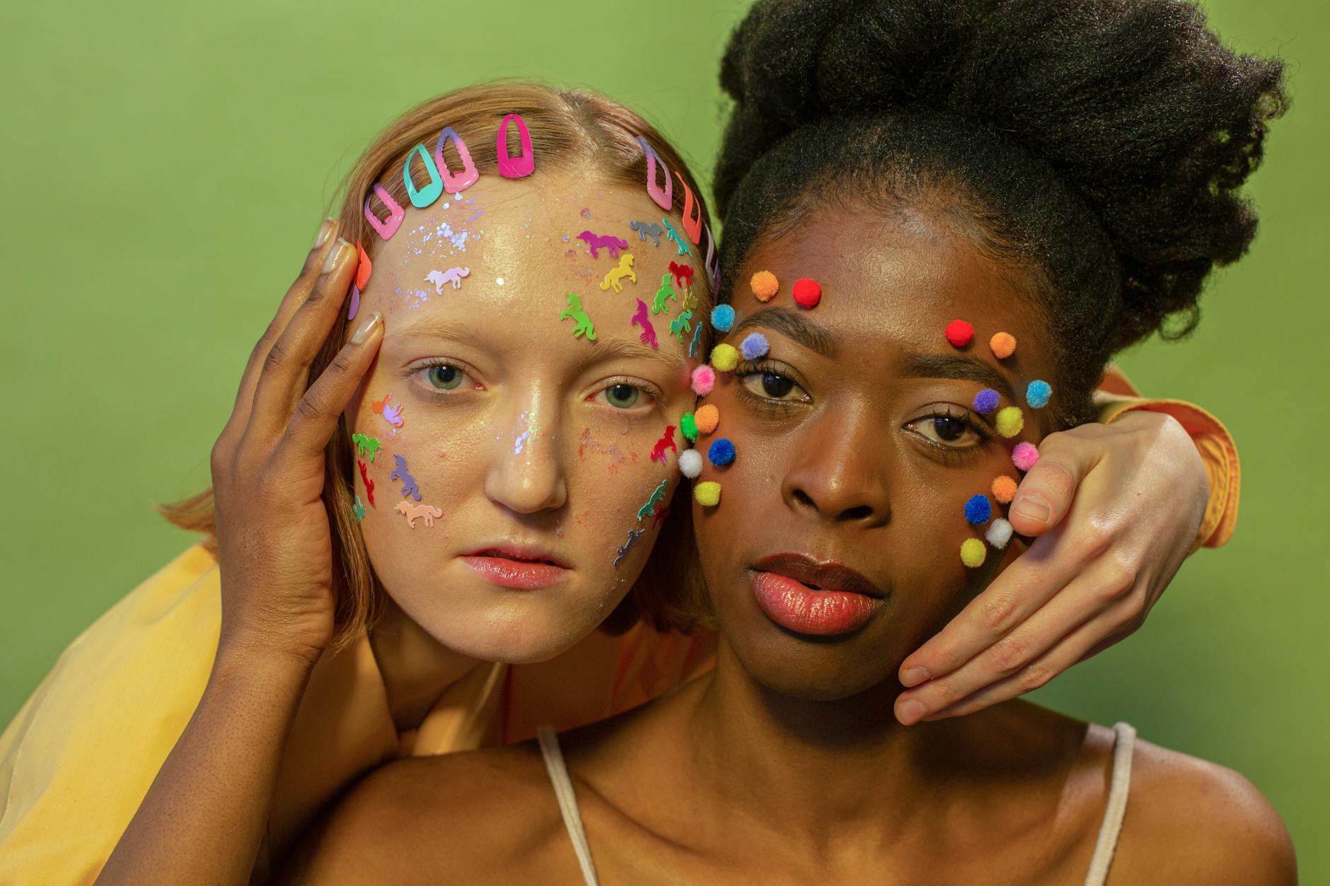 Multiracial women with bright decorations on face