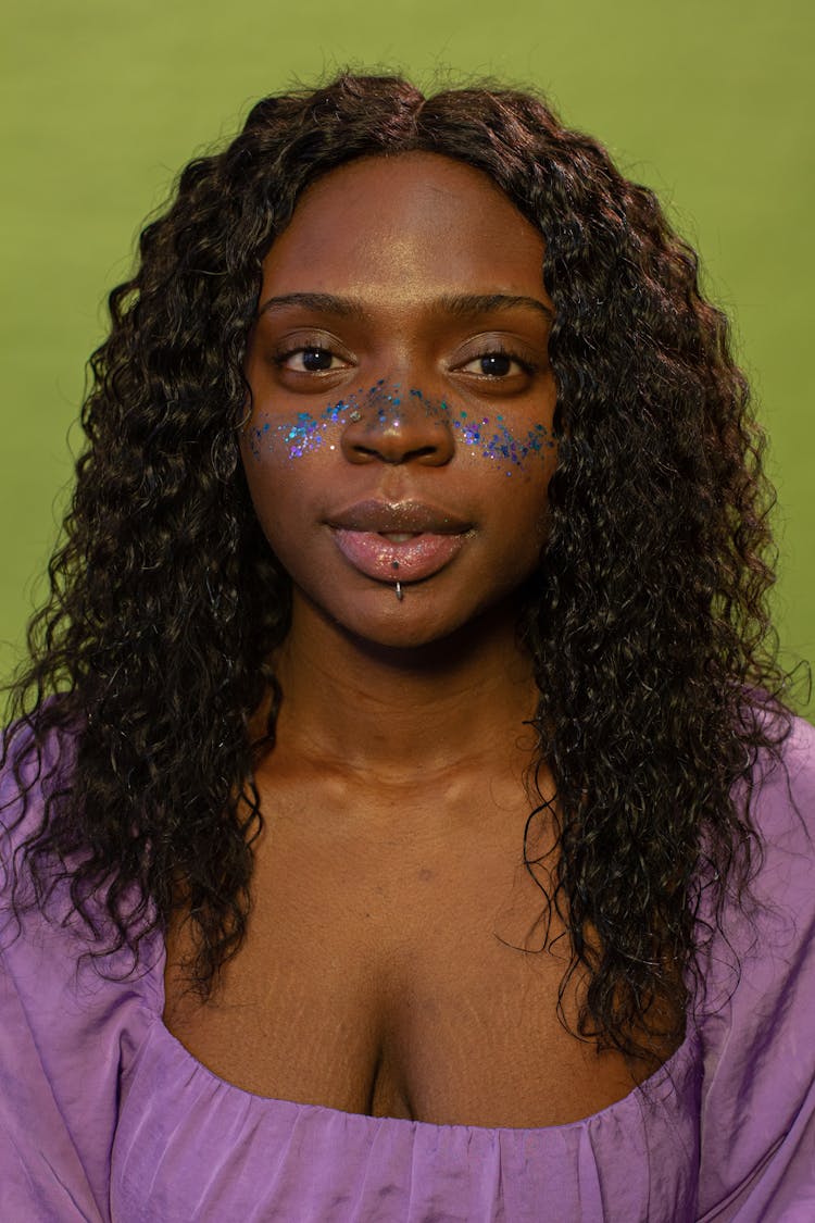 Black Alluring Woman With Blue Glitter And Piercing