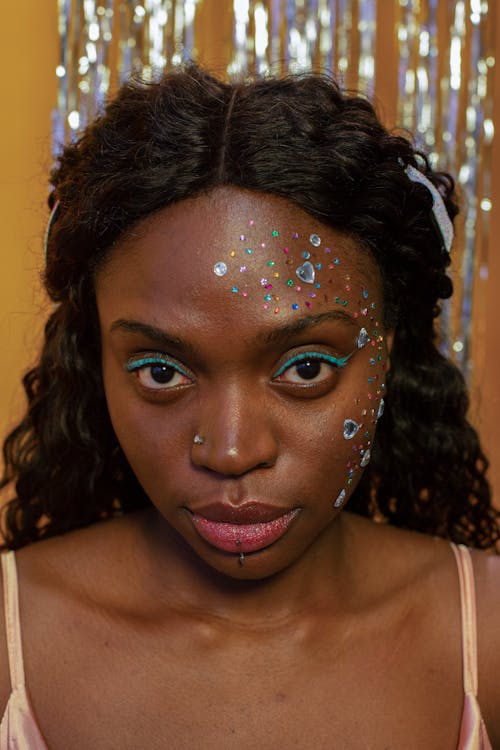 Black woman with decorative rhinestones on face